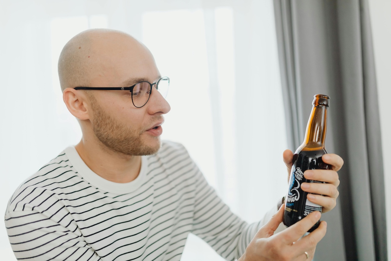 Person examining a beer label